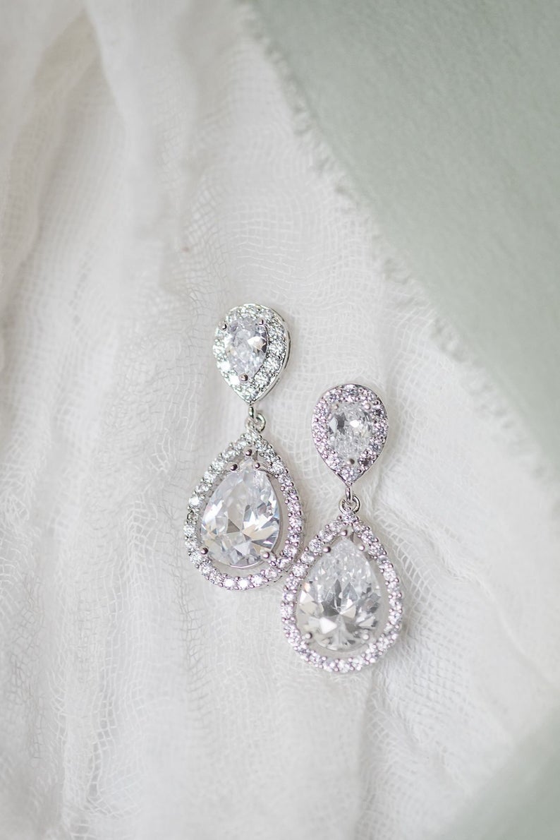 crystal silver earrings hanging on display