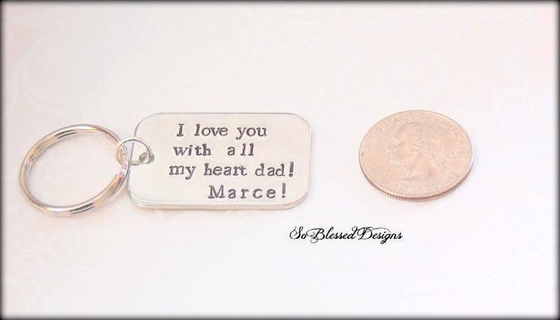 Father of the bride keychain next to quarter for size reference