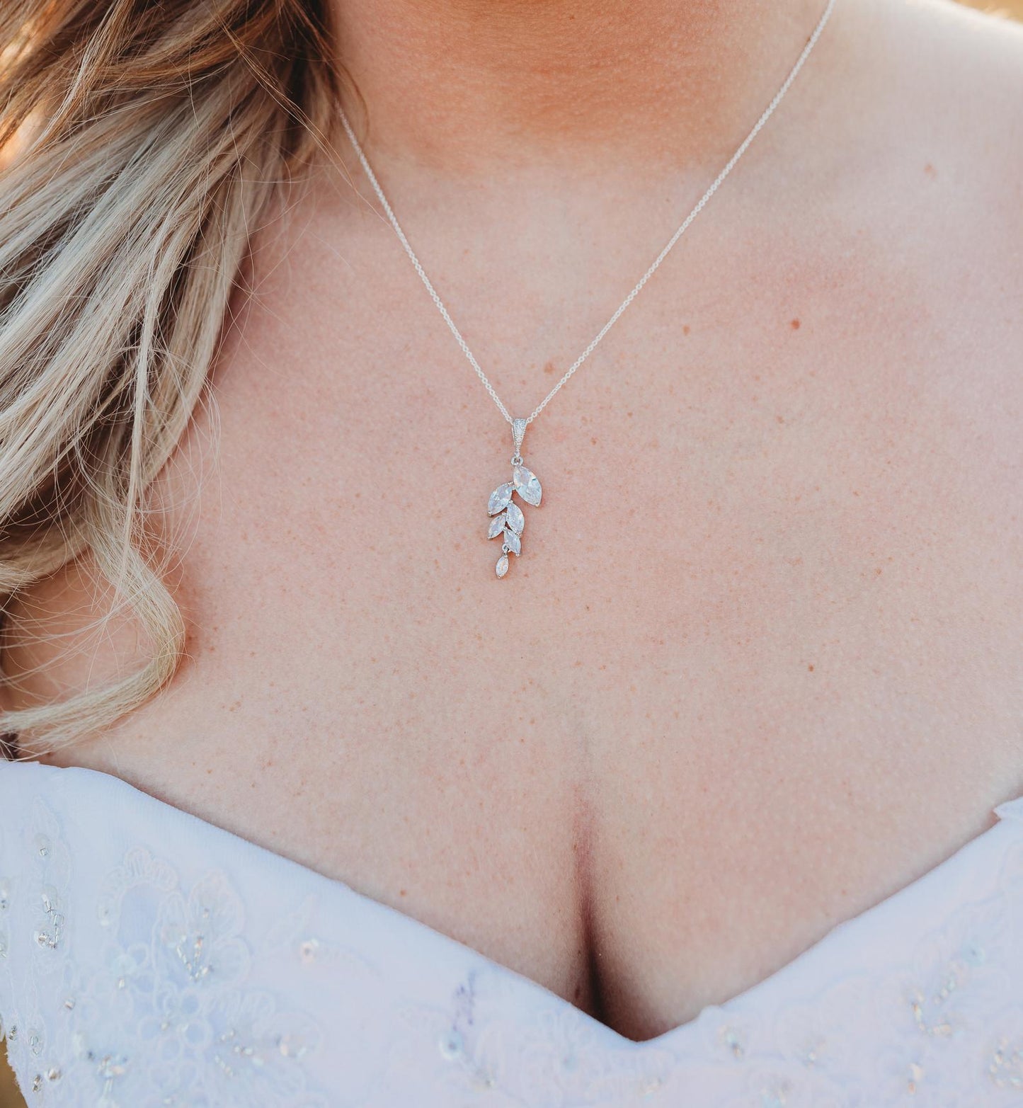 Bride wearing crystal leaf cubic zirconia necklace