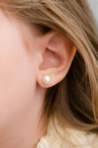Junior Bridesmaid showing her pearl stud earrings