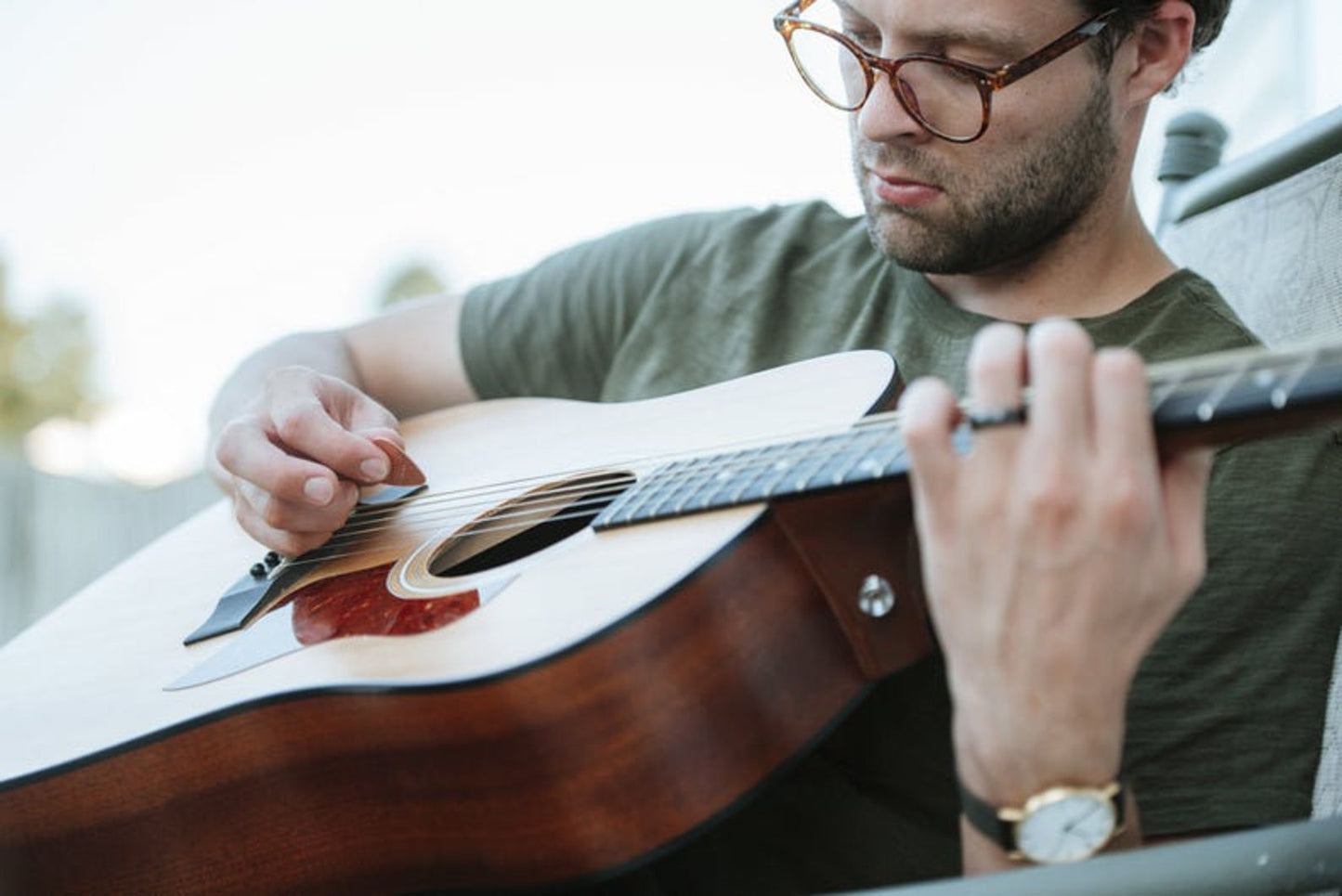 Man using hand stamped copper guitar pick
