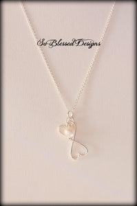 Silver double connecting hearts with pearl charm attached